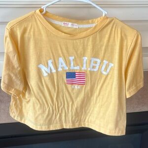 Light yellow Malibu cropped graphic tee.